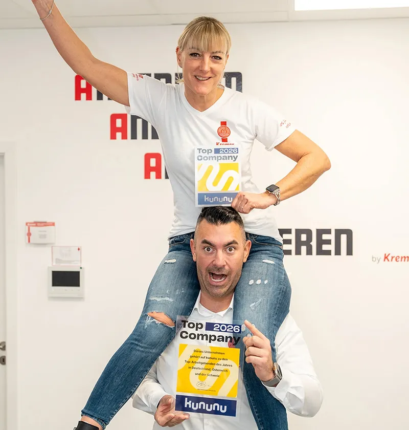 Zwei Mitarbeiter vom Pflegedienst Kremer im Main-Kinzig-Kreis präsentieren freudig die Auszeichnung als Top Company 2026 für ambulante Pflege MKK.